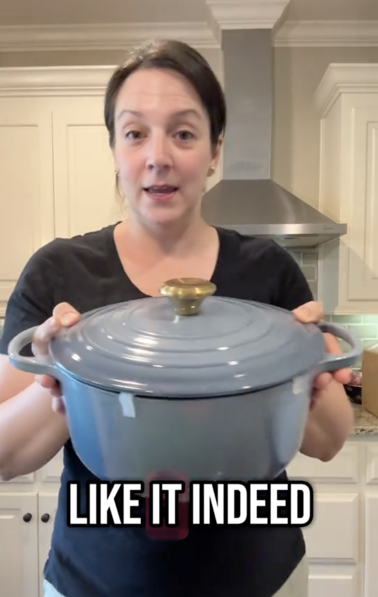 woman holding a dutch oven